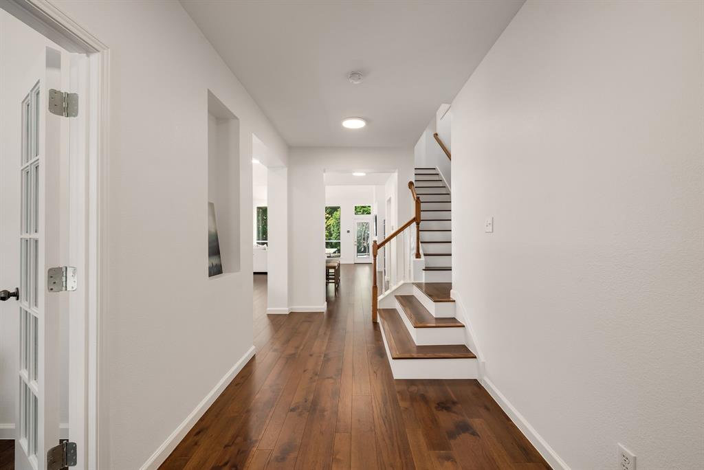 2524 Windgate Drive Frisco, TX 75033 - Photo 6 of 38 a view of a hallway with wooden floor and staircase