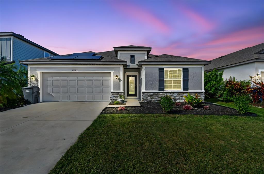 a front view of a house with a yard and garage