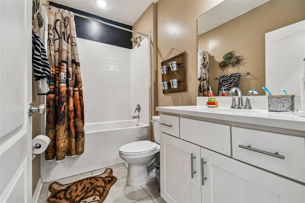 8207 Abalone Loop Palmetto, FL 34221 - Photo 17 of 37 a bathroom with a sink toilet and shower