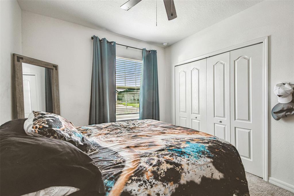 8207 Abalone Loop Palmetto, FL 34221 - Photo 18 of 37 a bedroom with a bed and a window