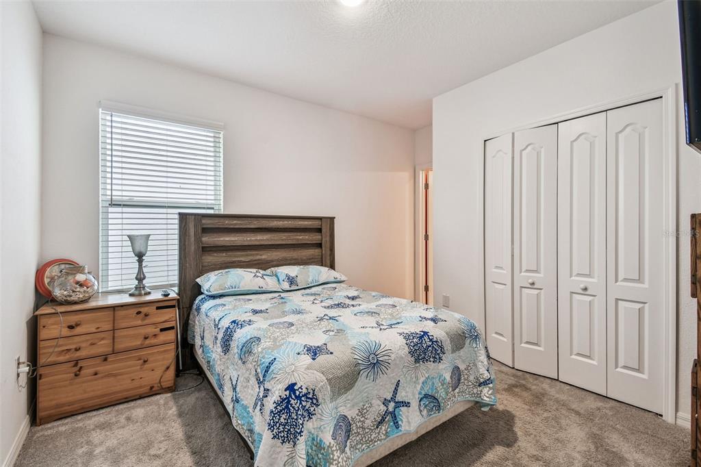 8207 Abalone Loop Palmetto, FL 34221 - Photo 19 of 37 a bedroom with a bed and a window