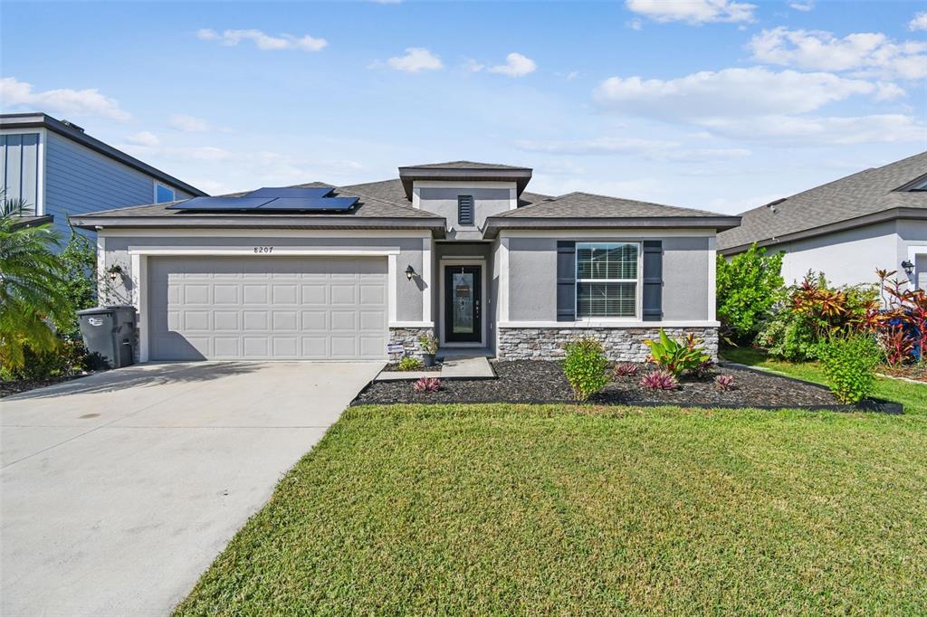 8207 Abalone Loop Palmetto, FL 34221 - Photo 2 of 37 a front view of house with yard