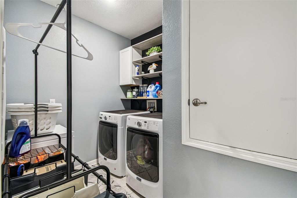 8207 Abalone Loop Palmetto, FL 34221 - Photo 21 of 37 a view of a storage and utility room with washer and dryer