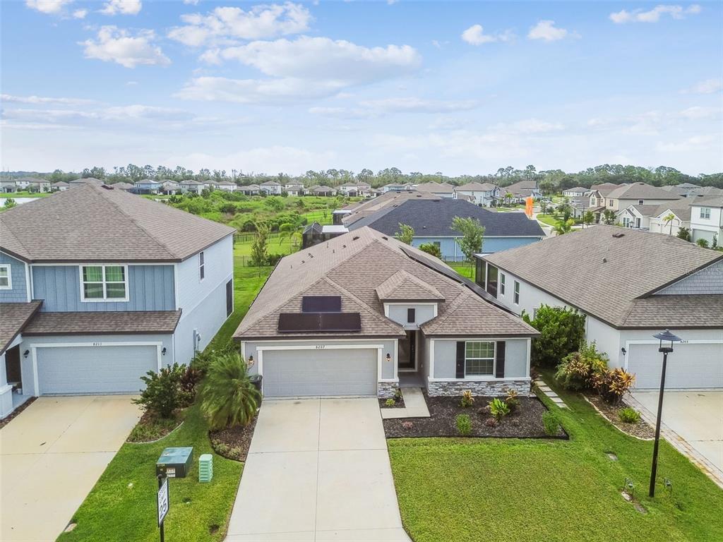 8207 Abalone Loop Palmetto, FL 34221 - Photo 30 of 37 a aerial view of a house with a yard and potted plants