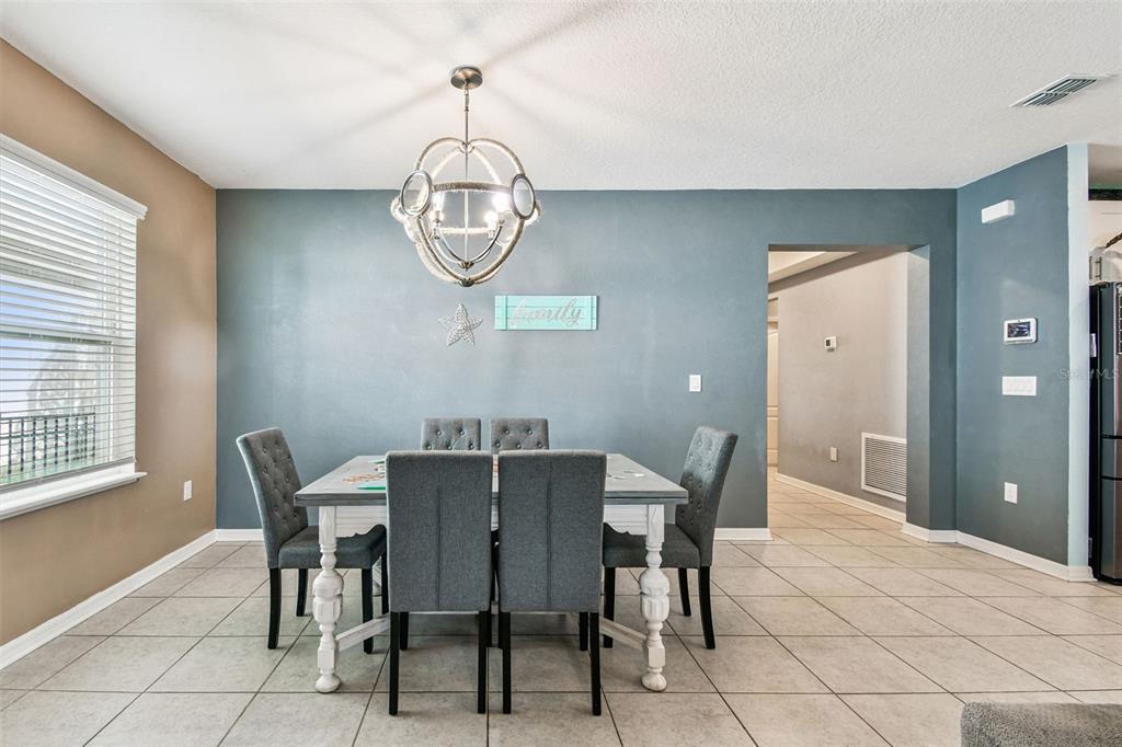 8207 Abalone Loop Palmetto, FL 34221 - Photo 7 of 37 a view of a dining room with furniture window and chandelier