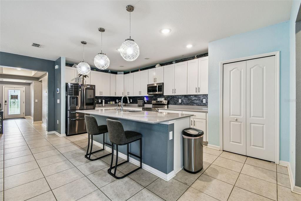 8207 Abalone Loop Palmetto, FL 34221 - Photo 9 of 37 a kitchen with stainless steel appliances granite countertop a stove and a refrigerator