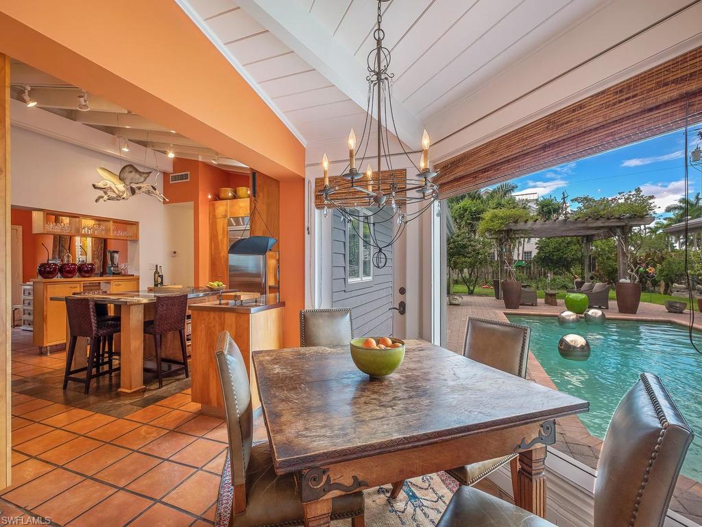 a view of a dining room with furniture a chandelier and wooden floor