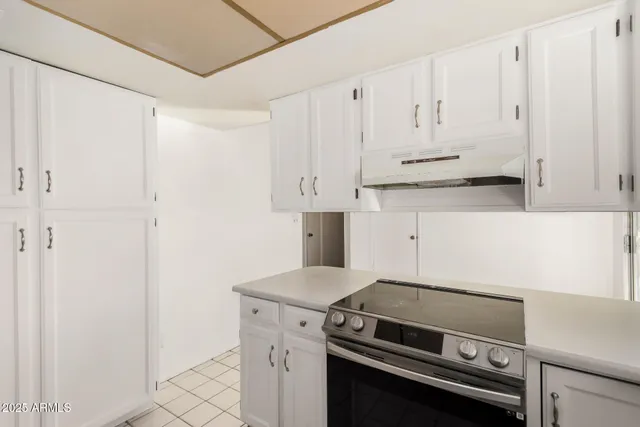 a view of kitchen with white cabinets