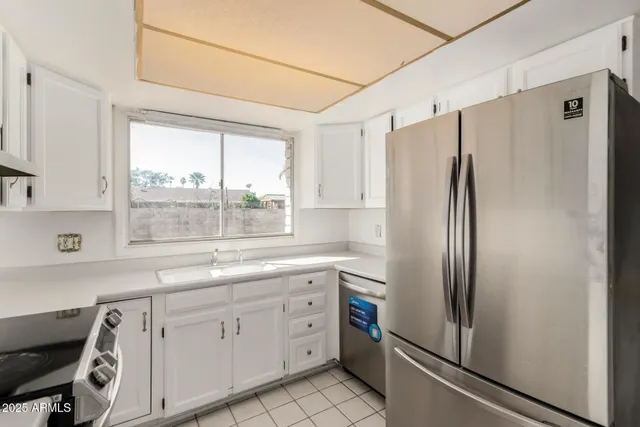 a kitchen with stainless steel appliances a refrigerator sink and cabinets