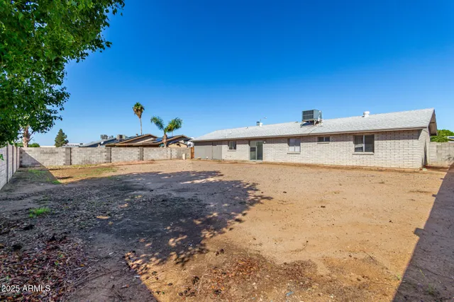 a view of lot of plants and trees with wooden fence