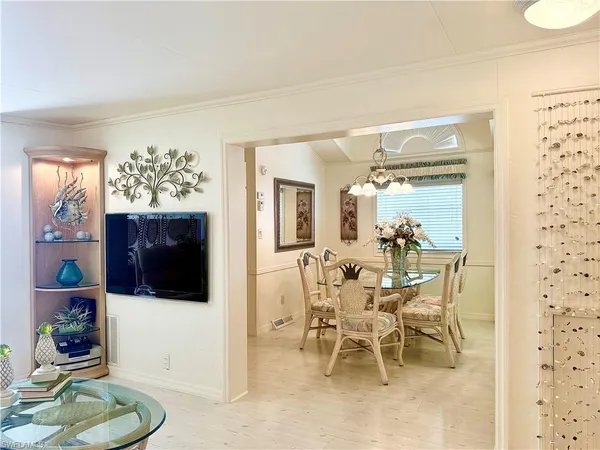a view of a dining room with furniture and chandelier