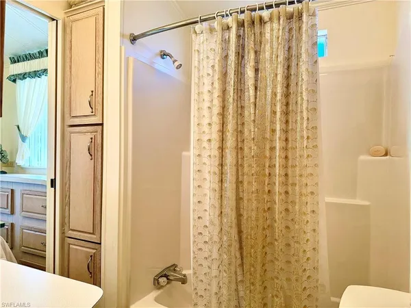 a view of sign board with buildings in background