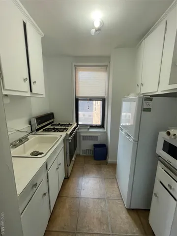 a kitchen with a sink a refrigerator and a stove