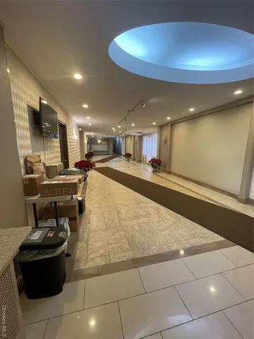 a living room with stainless steel appliances kitchen island granite countertop a sink a stove and a refrigerator