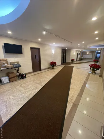 a view of a living room a kitchen island sink and a refrigerator