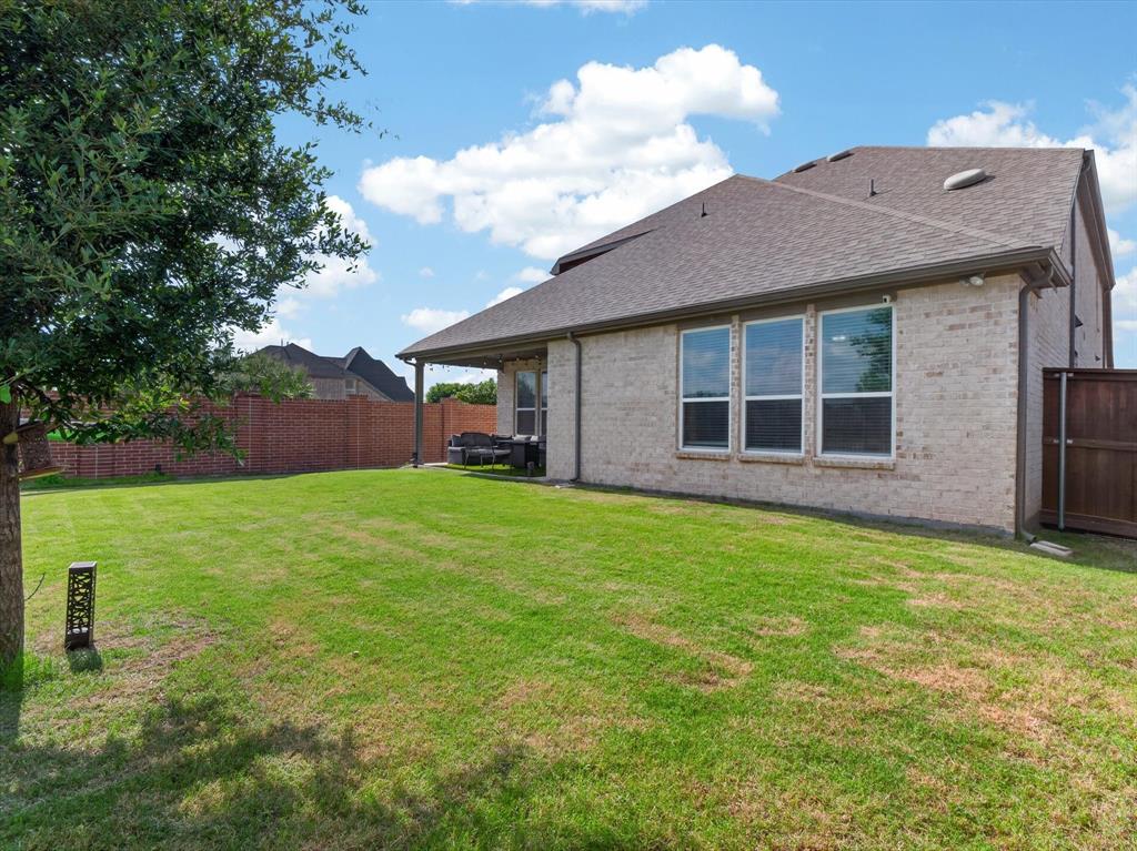 636 Corner Post Path Celina, TX 75009 - Photo 33 of 40 Expansive green lawn with a mature tree providing natural shade