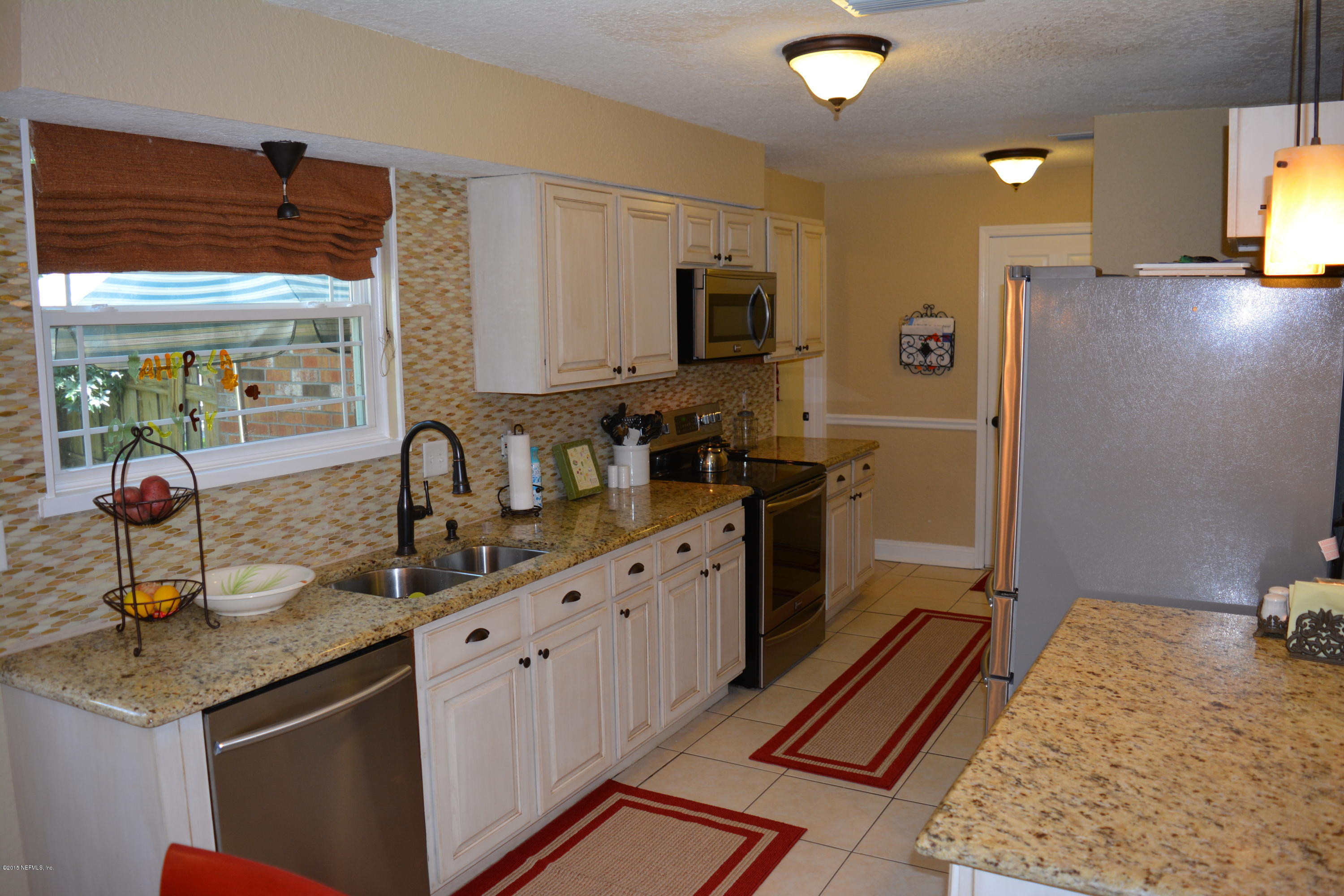 4264 Cedar Road Orange Park, FL 32065 - Photo 3 of 41 a kitchen with sink refrigerator and microwave