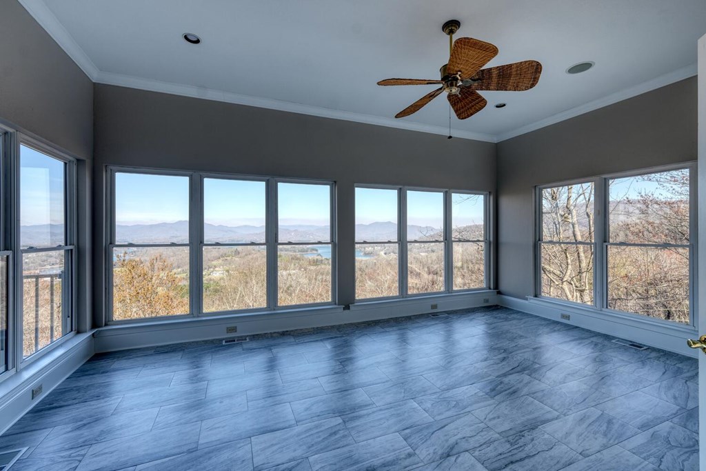 1436 Harris Ridge Road Young Harris, GA 30582 - Photo 18 of 86 an empty room with wooden floor and windows