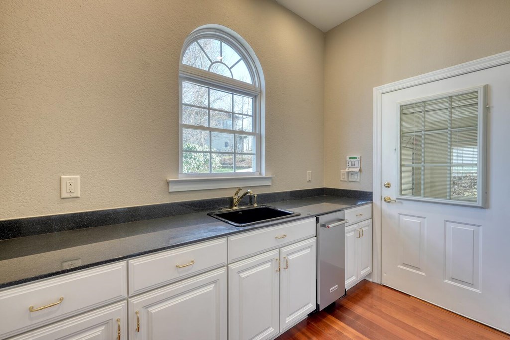 1436 Harris Ridge Road Young Harris, GA 30582 - Photo 30 of 86 a kitchen with granite countertop white cabinets and a window