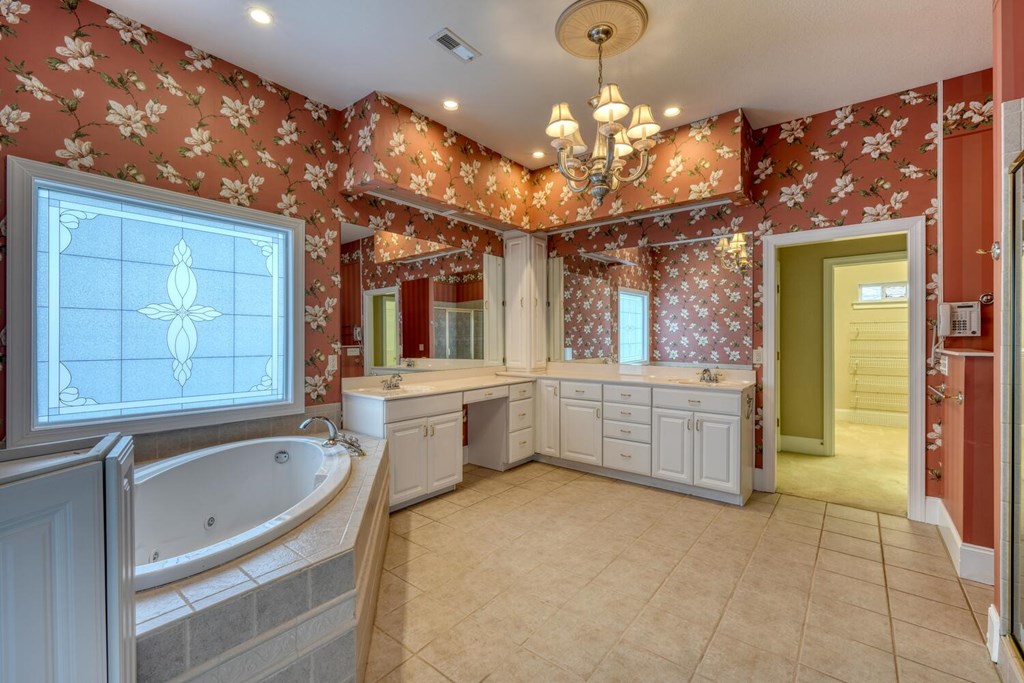 1436 Harris Ridge Road Young Harris, GA 30582 - Photo 36 of 86 a large bathroom with a large tub a sink shower and view of living room