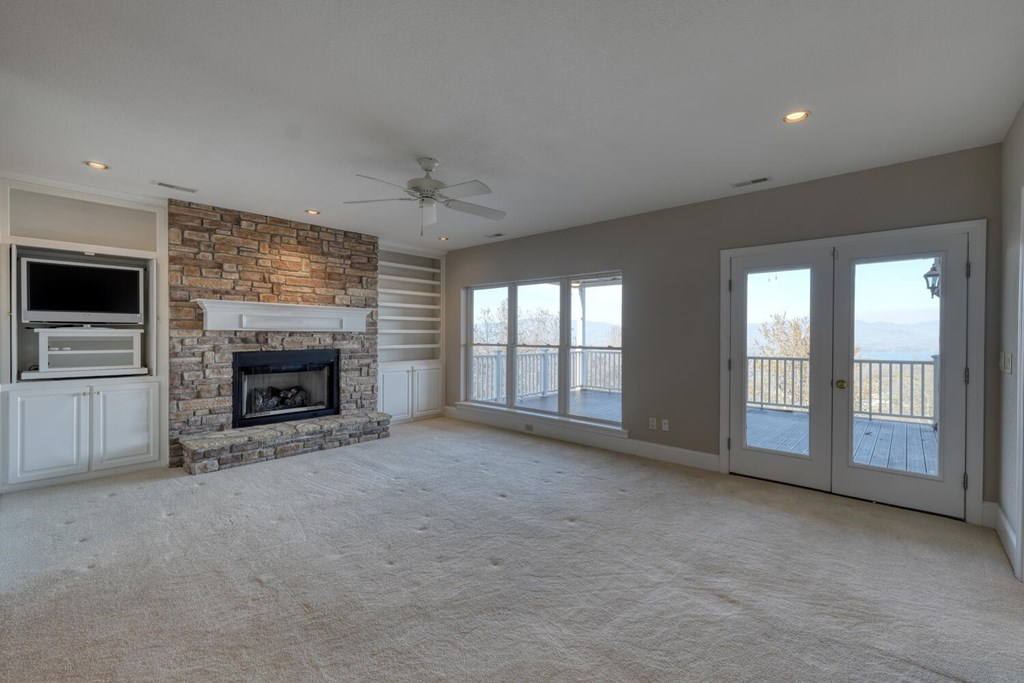 1436 Harris Ridge Road Young Harris, GA 30582 - Photo 46 of 86 a view of an empty room with a fireplace and a window
