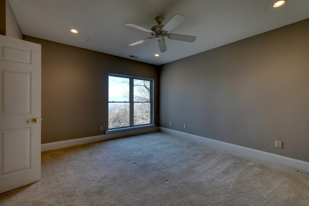 1436 Harris Ridge Road Young Harris, GA 30582 - Photo 53 of 86 an empty room with a ceiling fan and windows