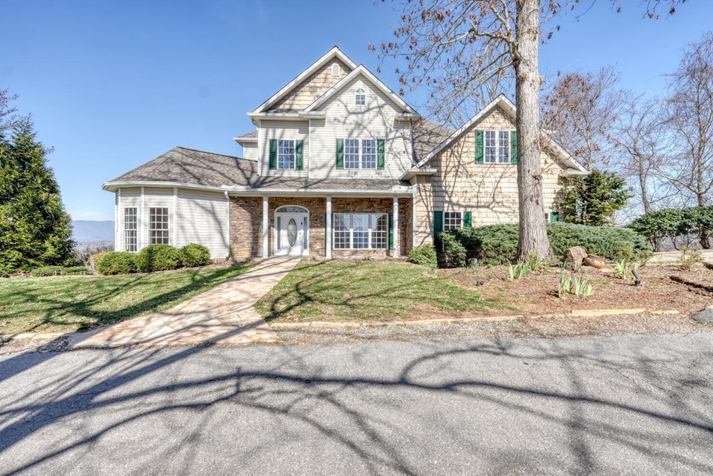 1436 Harris Ridge Road Young Harris, GA 30582 - Photo 7 of 86 a view of a white house next to a yard with big trees