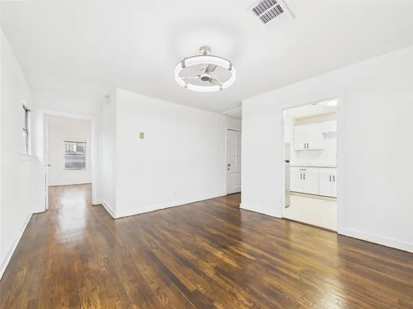 an empty room with wooden floor