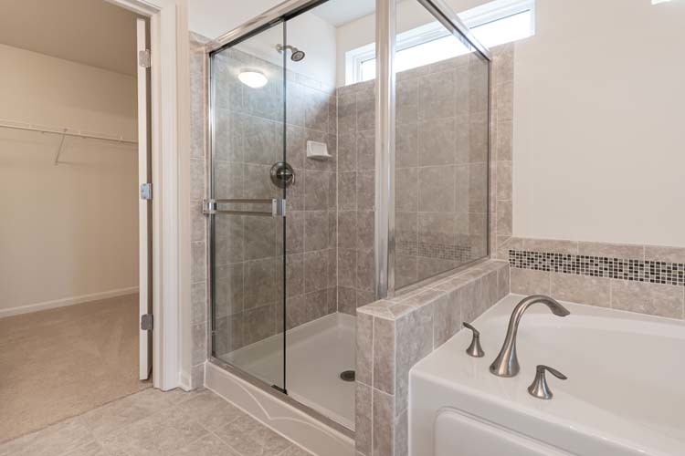 933 Willow Road Manteno, IL 60950 - Photo 12 of 20 a bathroom with a bathtub and shower