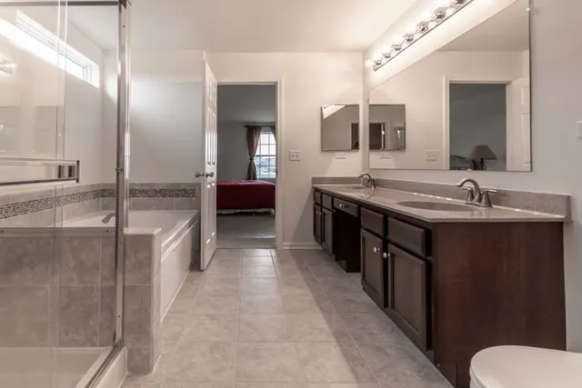 a large bathroom with a double vanity sink and a mirror