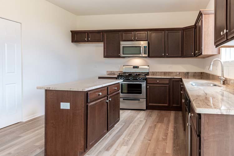 933 Willow Road Manteno, IL 60950 - Photo 3 of 20 a kitchen with a sink stove and microwave