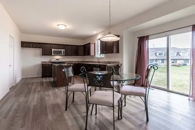 a view of a dining room with furniture window and wooden floor