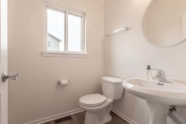 a bathroom with a sink toilet and a mirror
