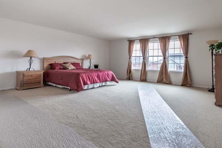 933 Willow Road Manteno, IL 60950 - Photo 10 of 20 a spacious bedroom with a large bed and a large window