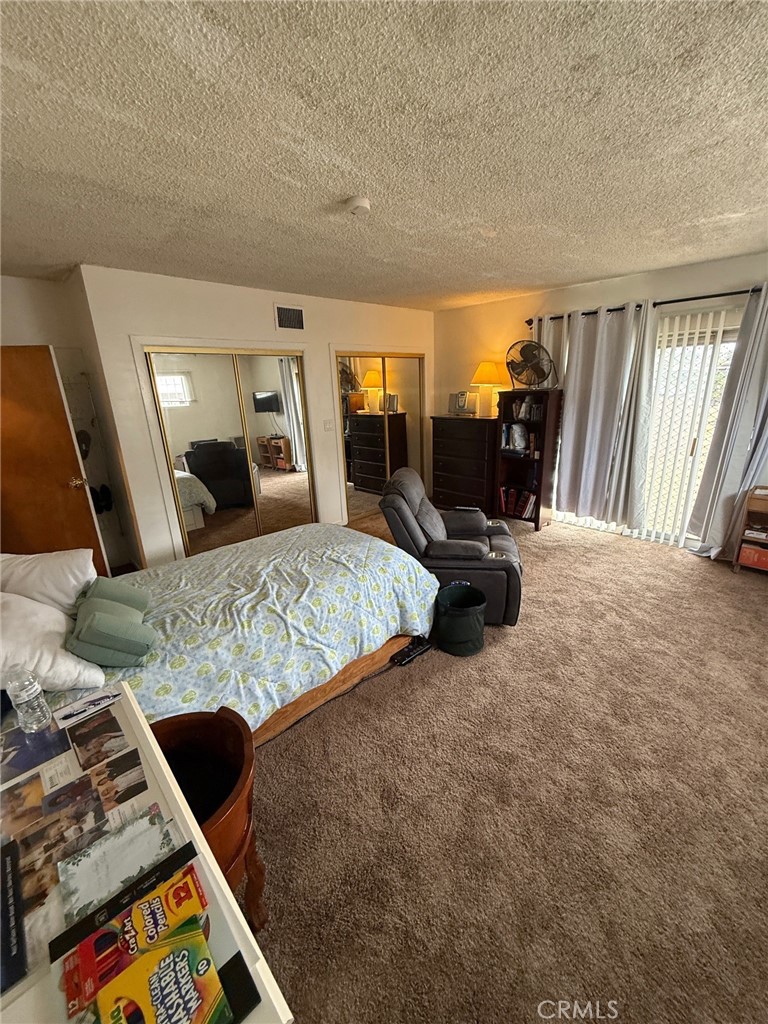 471 West Bennett Street Compton, CA 90220 - Photo 11 of 20 a bedroom with a bed and wooden floor