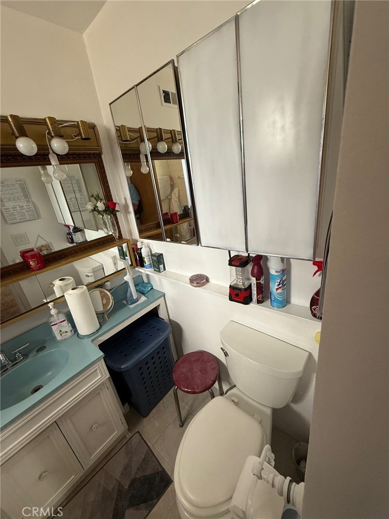 471 West Bennett Street Compton, CA 90220 - Photo 6 of 20 a white toilet sitting next to a bathroom sink and tub