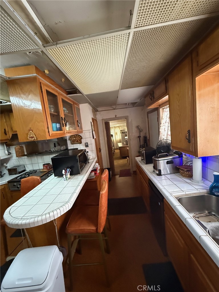 471 West Bennett Street Compton, CA 90220 - Photo 8 of 20 a kitchen with a table chairs sink and stove