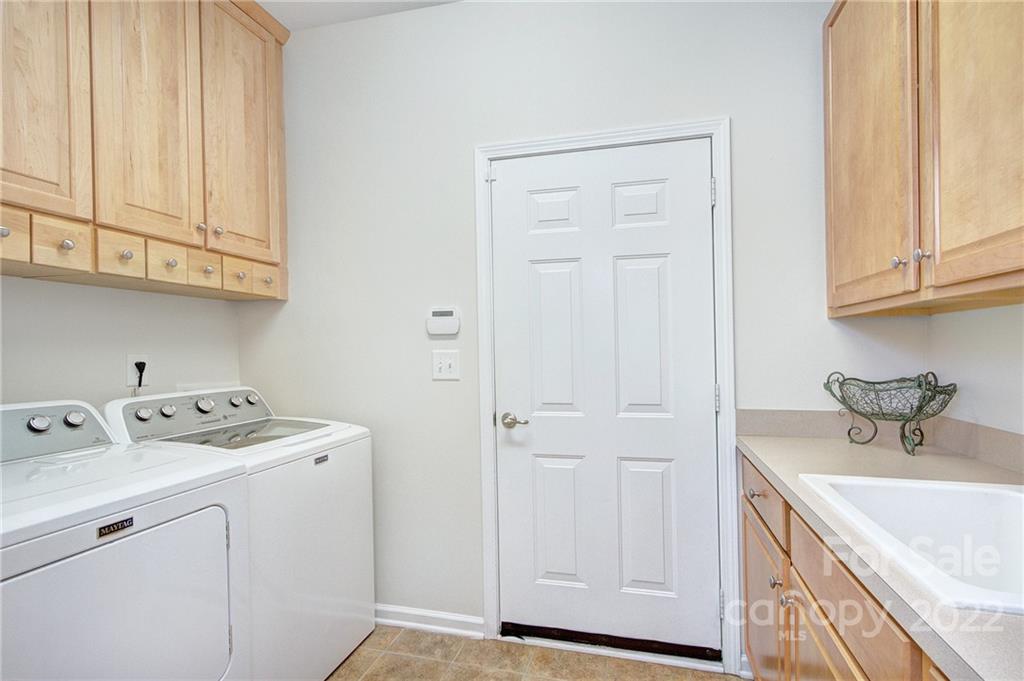256 Garnet Court Fort Mill, SC 29708 - Photo 23 of 34 a utility room with cabinets washer and dryer