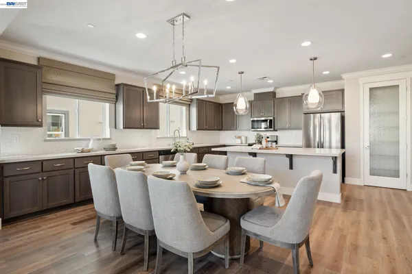 a large kitchen with a table and chairs