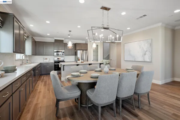a large kitchen with a table and chairs