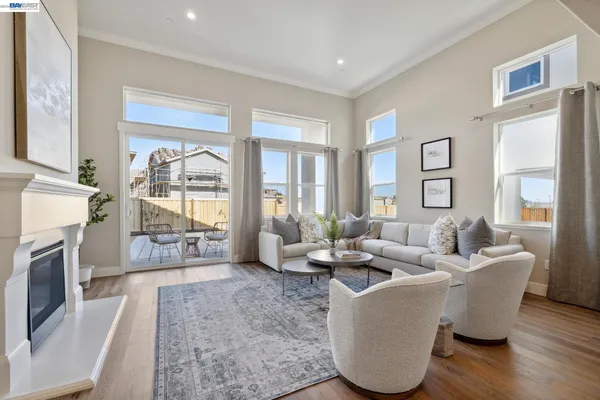 a living room with fireplace furniture and a large window