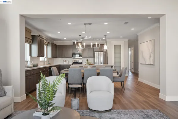 a living room with furniture a dining table and kitchen view