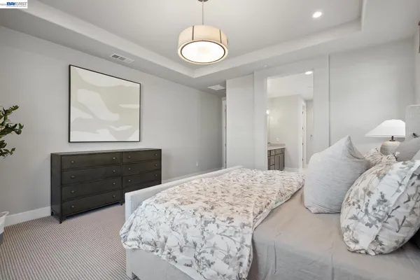 a bedroom with a bed and a chandelier