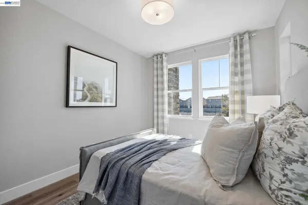 a bedroom with bed and a window