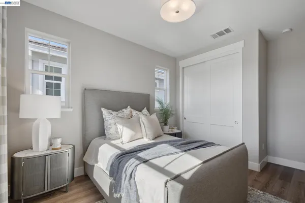 a bedroom with a bed and a lamp