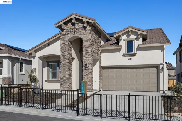 a front view of a house with a iron gate