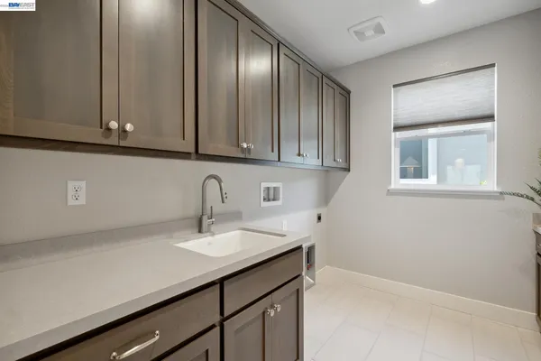 a view of a kitchen with sink and cabinets