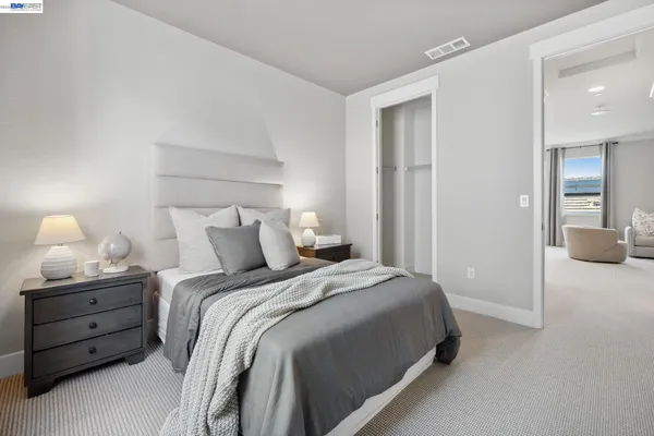 a bedroom with a bed and a lamp