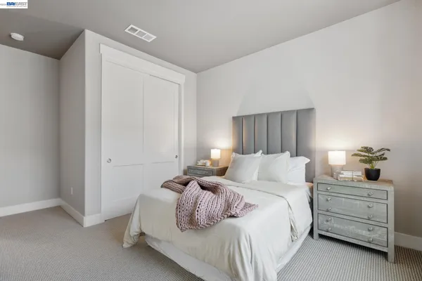 a bedroom with a bed and a dresser