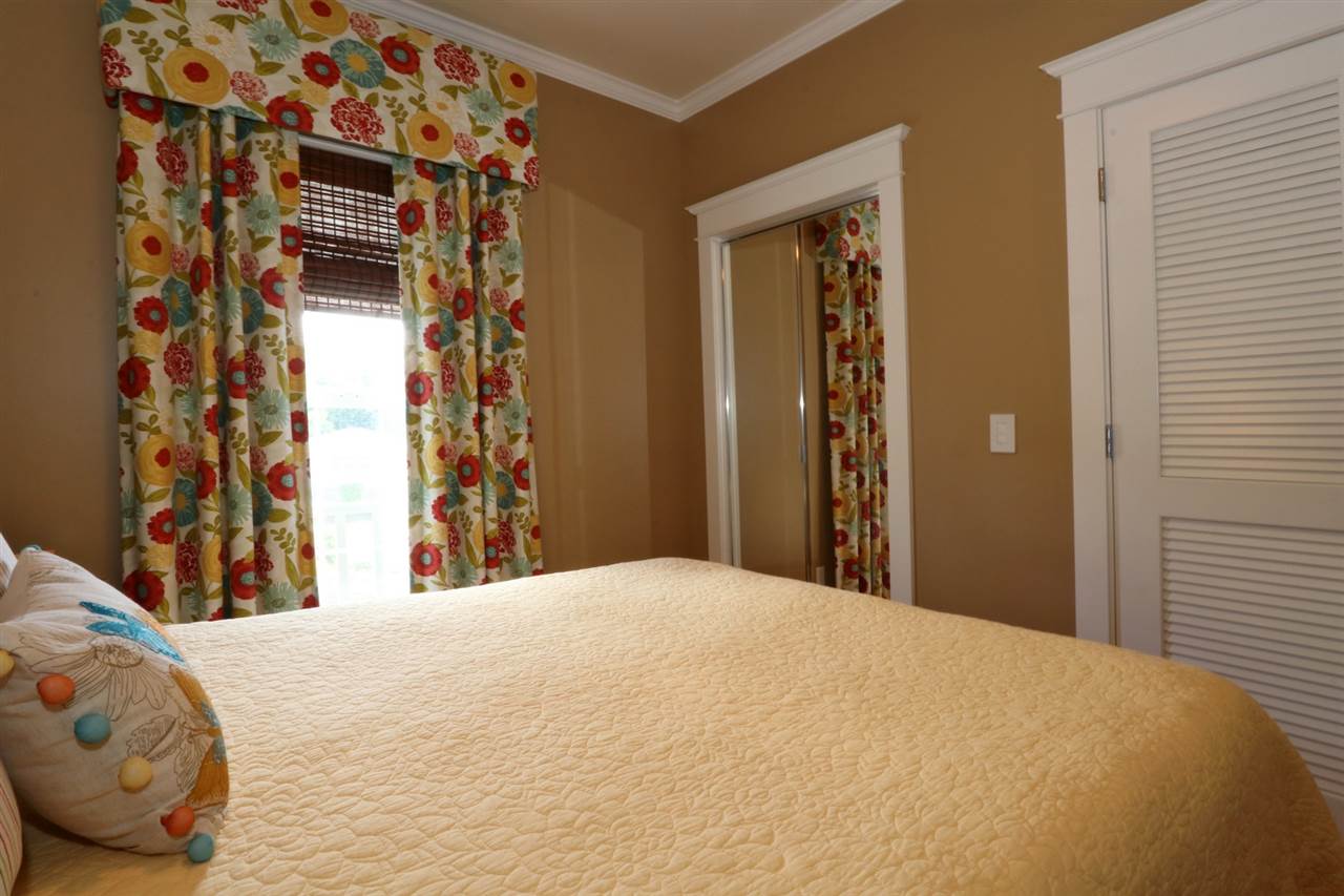 1268 Lower Kimo Drive Kula, HI 96790 - Photo 20 of 30 a bedroom with a bed and a mirror